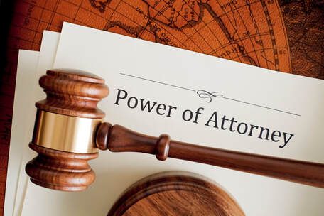 Picture of a judge's gavel sitting on top of Power of Attorney paperwork