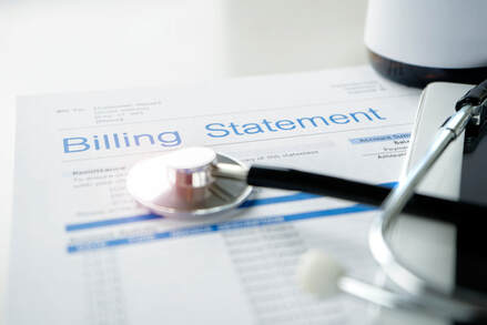 Picture of a medical billing statement with a stethoscope sitting on top of it